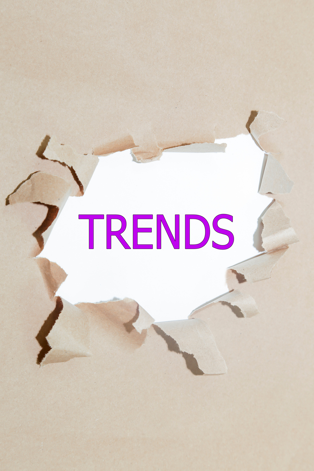 trends written under torn paper