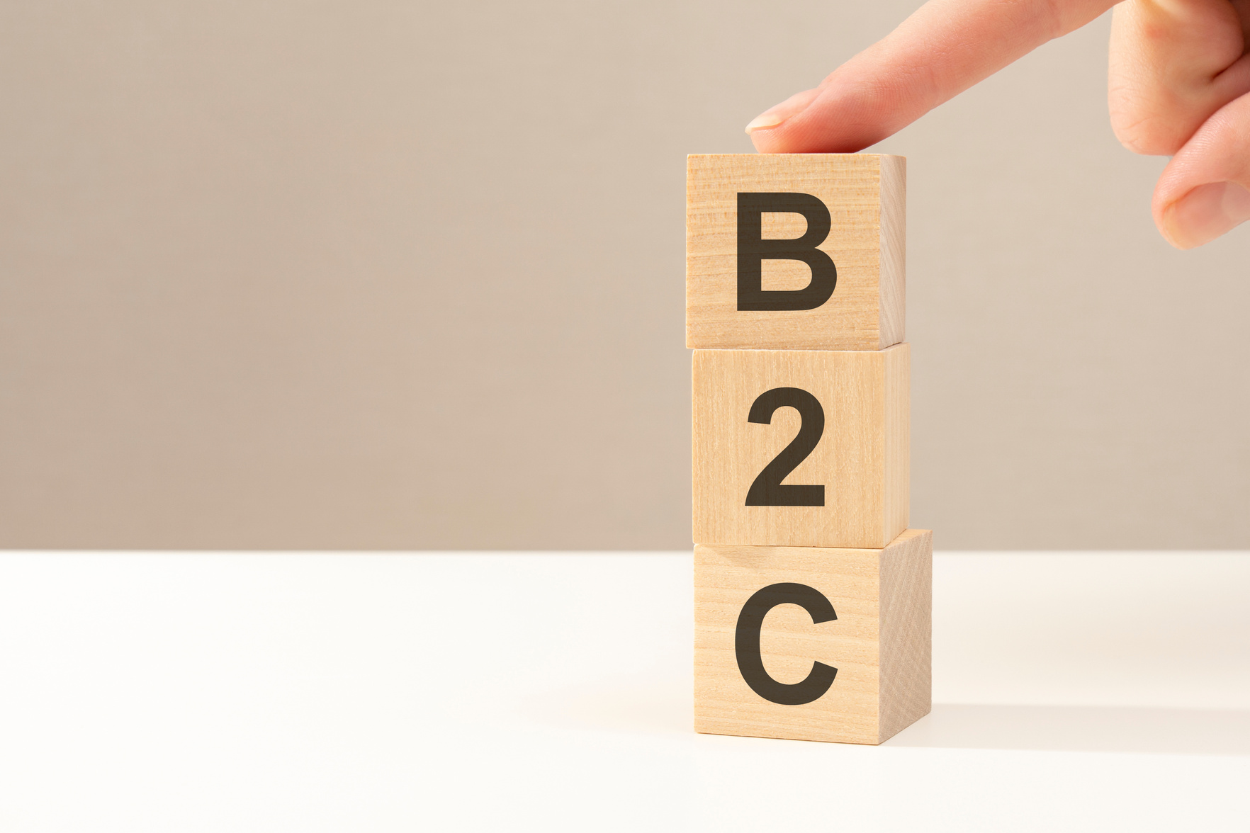 B2C - letters abbreviation on wooden cubes on a gray background